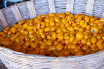 yellow tomato pear in a white basket