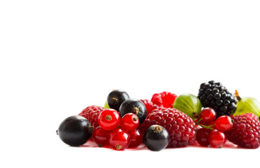 Ripe raspberries, gooseberries, blackberries, red and blackcurrants on white background. Background of mix fruits with copy space for text. Mix berries on white background. Red and black food.