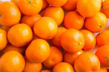 Top view. Fresh tangerines. Ripe and tasty mandarins. Clementines. Background tangerines.