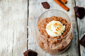 chocolate rice pudding decorated with whipped cream with cinnamon