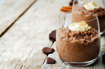 chocolate rice pudding decorated with whipped cream with cinnamon