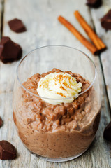 chocolate rice pudding decorated with whipped cream with cinnamon