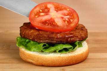 Put Tomato on Patty. Making Hamburger. Macro. Series.