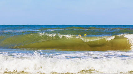 Sea waves during a storm on a sunny day