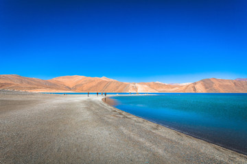 Pangong Tso Lake with Rocky Mountains in Background