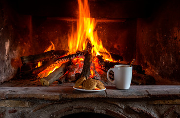 National, Christmas greek cookies "melomacarona" and a cup of coffee on the background of the fireplace