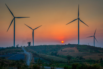 Landscape View of Wind Turbines on Hill at Sunset Dusk Sky