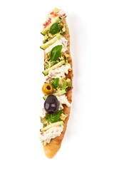 Bruschetta with cottage cheese, cucumber, tomatoes, olives and herbs. Spanish Tapas and Pinchos, isolated on white background