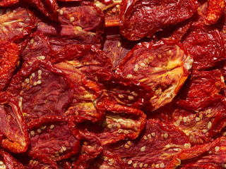Sun Dried tomatoes in the sunshine on white
