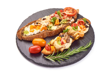 Spanish Tapas and Pinchos with cottage cheese, tomatoes, champignon mushrooms, zucchini, garlic and herbs on a stone plate, Italian Bruschetta, isolated on white background