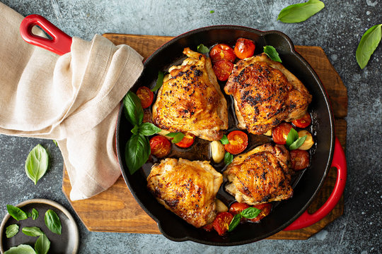 Chicken thighs roasted with tomatoes and garlic, quick dinner dishrecipe