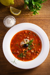 Solyanka - thick, spicy and sour Russian soup, made of beef, ham, sausages, chicken breast cucumber...