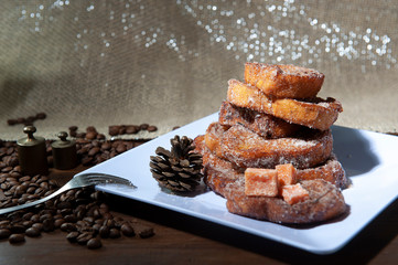 French toast, sliced sweet bread, unfocused foreground. Selective focus .Coffee beans. White dish, dark background .Christmas sky.Breakfast.View from above. From above.Light background, defocused silv