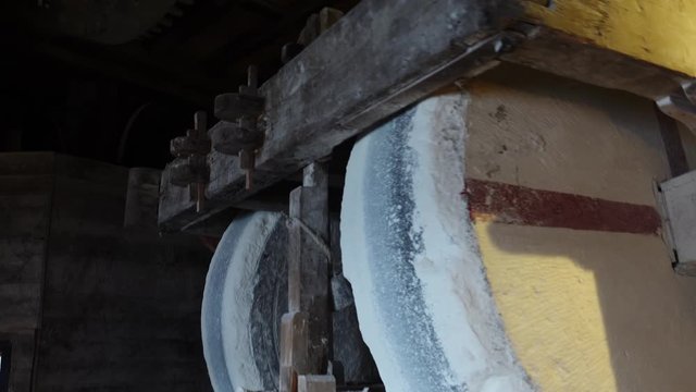 Zaandam Zaanse Schans near Amsterdan inside a typical dutch windmill close up of large wooden wheels grinding peanuts