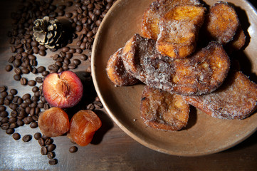 French toast, sliced bread sweet.Selective focus .Coffee beans.Plum, dried apricot.Christmas jelly.Breakfast.View from above. From above.Light background, defocused silver sparkle. Horizontal.