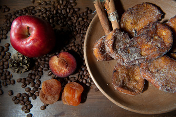 French toast, sliced bread sweet.Selective focus .Apple, plum, apricot.Coffee beans. Christmas supper table. Breakfast. From above. Dark background. Horizontal.