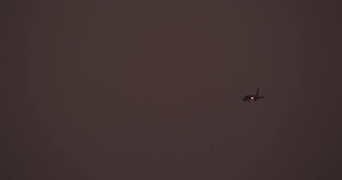 Helicopter aerial shot of aircraft among clouds, sundown