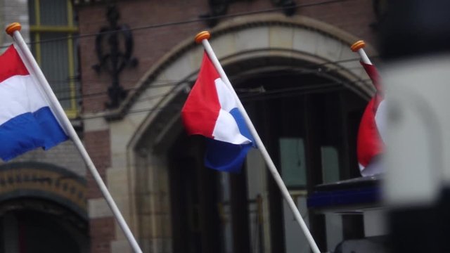 Flags of Netherlands in the center of Amsterdam. Slow motion