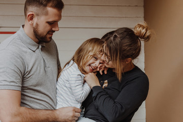 Family with little girl in city street