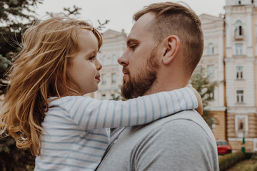 Young man holding little girl