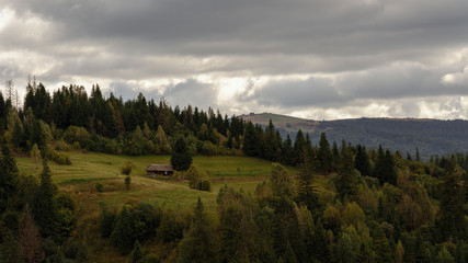 Tiny cabin alone on the peak of carpathian mountains