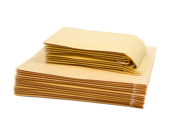Stack of padded mailing envelopes isolated against a white background