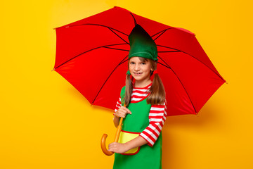 Christmas elf holding an opened umbrella