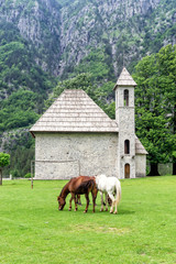 Fototapeta na wymiar Church in the Theth Valley, on Background the Mountains of Albanian Alps, Albania
