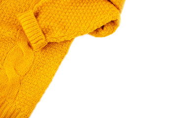 Texture of orange woolen knitted sweater over white background with copy space. Comfort warm clothers for the cold weather concept