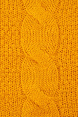Texture of orange woolen knitted sweater