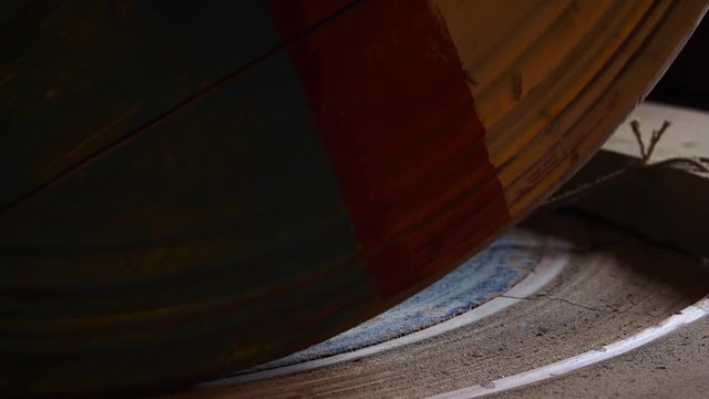 Zaandam Zaanse Schans near Amsterdan inside a typical dutch windmill close up of large wooden wheels grinding peanuts. Slow motion