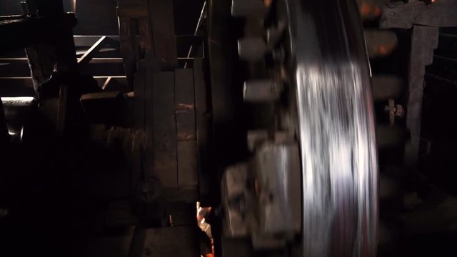 Close up gears of mill stones processing grain inside a windmill at zaanse schans near amsterdam, netherland. Slow motion