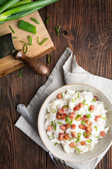 Bryndzove Halusky, national dish in Slovakia, potato dumplings with sheep cheese and sour cream, topped with roasted bacon pieces and spring onion