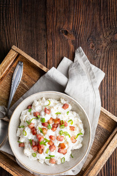 Bryndzove Halusky, national dish in Slovakia, potato dumplings with sheep cheese and sour cream, topped with roasted bacon pieces and spring onion