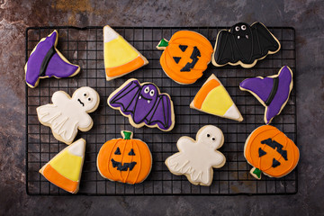 Halloween sugar cookies with icing on a cooling rack