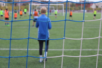 young boy playing soccer FOOTBALL NET