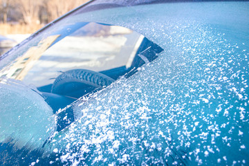 cleared the frost on the windshield in the cold, front and rear blurring the background