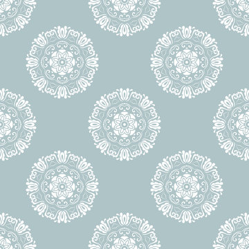 Floral vector ornament. Seamless abstract classic background with flowers. Pattern with repeating white round elements. Ornament for fabric, wallpaper and packaging