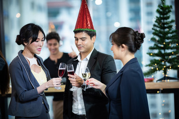 Toast to success. Group of business people toasting with champagne and smiling while standing close to each