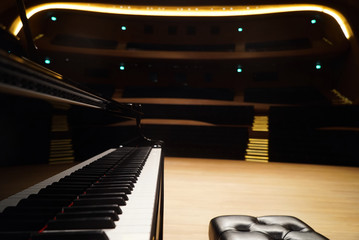 Grand Piano and seat in Concert Hall, close-up.