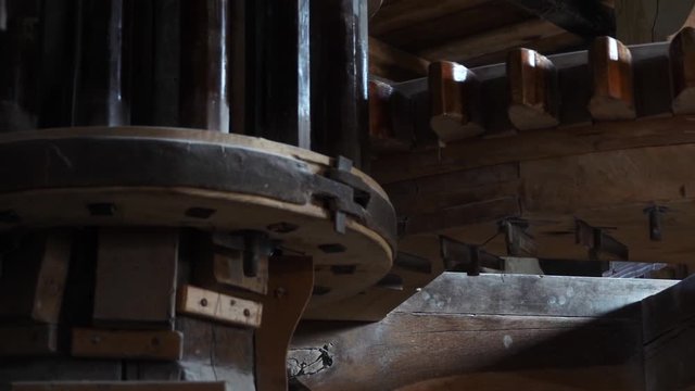 Close up of mill stones processing grain inside a windmill at zaanse schans near amsterdam, netherland. Slow motion