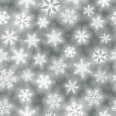 Christmas seamless pattern of white snowflakes of different shapes on gray background