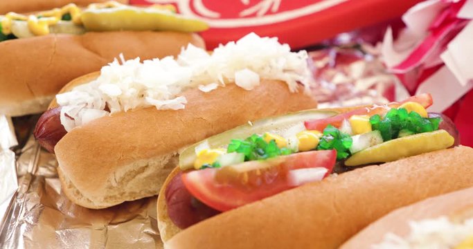 Video Slide Across Hot Dogs With Someone Taking A Bite Of One
