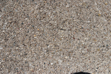 Concrete sidewalk texture with large rocks