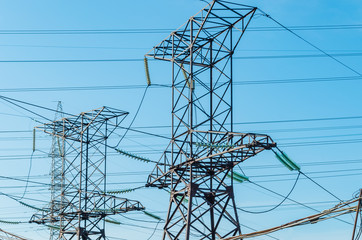 power transmission towers on background of blue sky