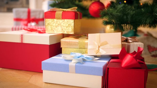 4k video of camera slowly zoming on big heap of Christmas gifts and presents lying on floor under Christmas tree. Perfect shot for your winter holidays and celebrations