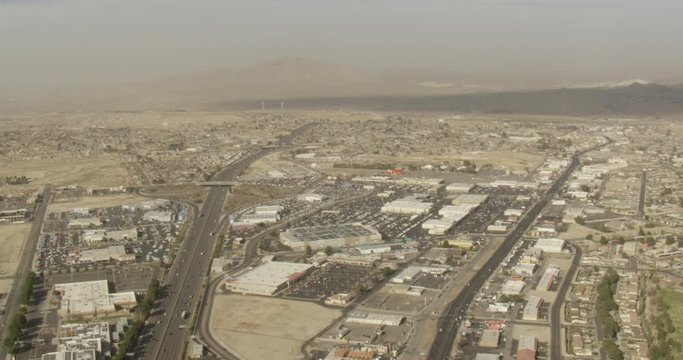 Aerial shot, day, high altitude view of desert town, drone