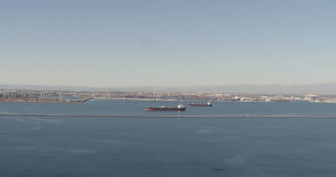 Aerial helicopter shot, fly towards container ships, Long Beach warf, drone footage