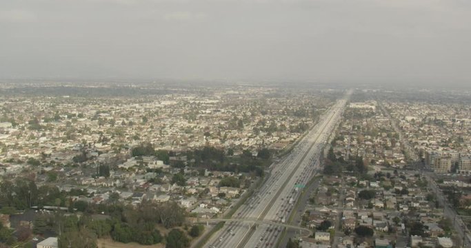 Aerial shot, day, high altitude view of southern california highway and town, drone