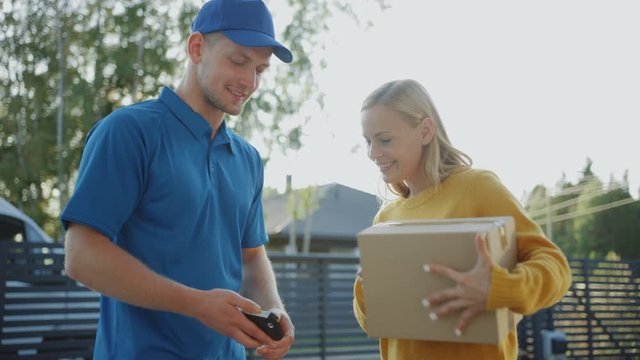 Beautiful Young Woman Opens Doors of Her House and Meets Delivery Man who Gives Her Cardboard Box Package, She Signs Electronic Signature POD Device. 